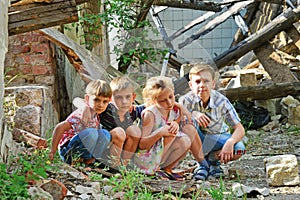 Children are near the ruined house, the concept of natural disaster, fire, and devastation.