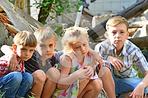 Children are near the ruined house, the concept of natural disaster, fire, and devastation.