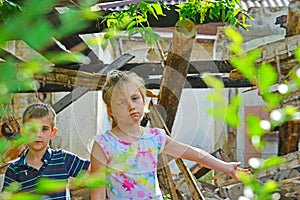 Children are near the ruined house, the concept of natural disaster, fire, and devastation.