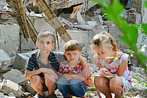 Children are near the ruined house, the concept of natural disaster, fire, and devastation.