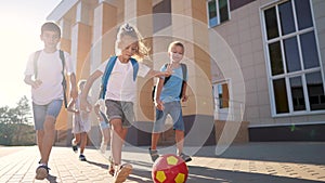 children near the school playing soccer. kids a school education kid dream concept. a group of children near the school