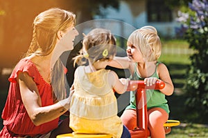 Children and nursery school teacher playing outdoors