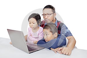 Children observing seriously their father teaching