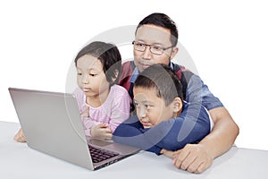 Children observing their father teaching them