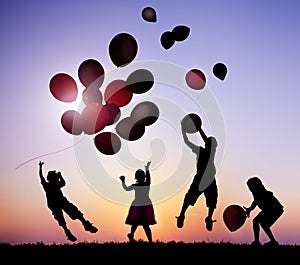 Children Outdoors Playing with Balloons