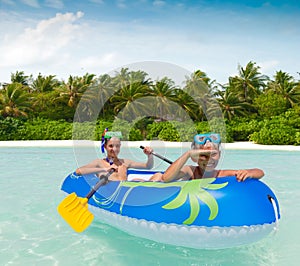 Children paddling rubber raft photo