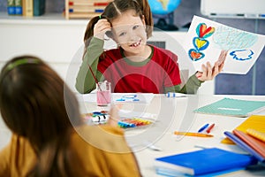 Children painting in art class at elementary school