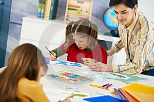 Children painting in art class at elementary school