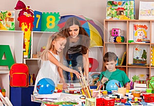 Children painting and drawing together. Craft lesson in primary school.