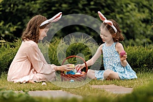 children with painting eggs outdoors