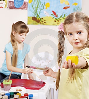 Children painting in preschool.