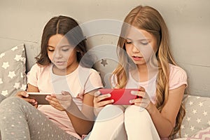 Children in pajama interact with smartphones. Application for kids fun. Internet surfing and absence parental advisory