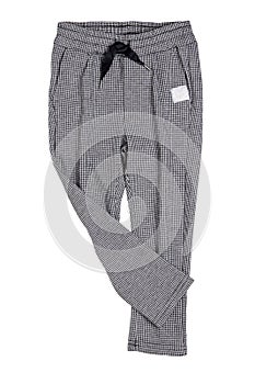 Children pants isolated. Close-up of a elegant gray white checkered trouser or sweatpants for child boy isolated on a white