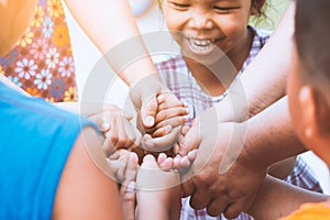 Children and parent holding hands and playing together