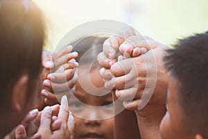 Children and parent holding hands and playing together