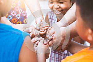 Children and parent holding hands and playing together