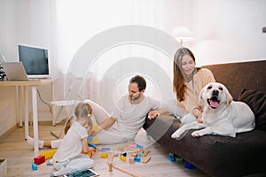 Children, parents and pet at home
