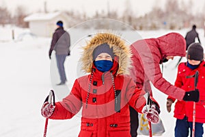Children in the park go skiing in winter