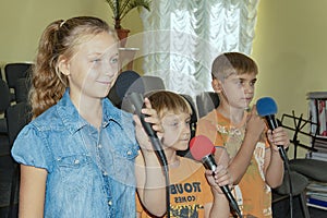 Children participate with a microphone, recite poems, recitation