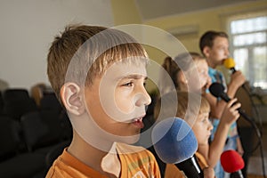 Children participate with a microphone, recite poems, recitation, sing songs