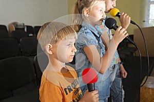 Children participate with a microphone, recite poems, recitation, sing songs