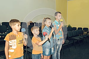 Children participate with a microphone, recite poems, recitation, sing songs