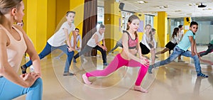 Children participating in dance class with teacher