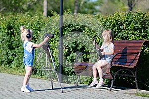 Children with photo appart in a city park