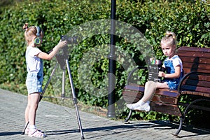 Children with photo appart in a city park