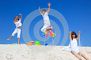 Children and pinwheels on sand
