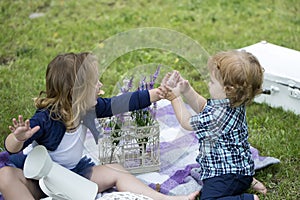 Children on pirnic. Cute little baby on the meadow field. Toddler child walking outdoor, family vacations, summer season