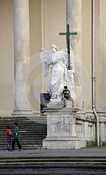 Children play at angel sculpture