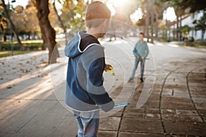 Children play badminton in the park.