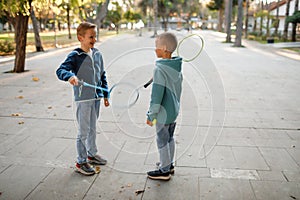 Children play badminton in the park.