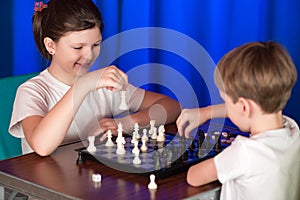 Children play a board game called chess.