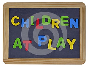 Children at play in colored letters on slate