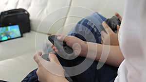 Children play console in gamepads teamwork. kids a boy and a girl are playing a portable set-top box in a TV controller