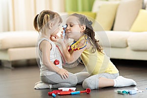 Children play doctor and hospital using toy medical tool having fun at home