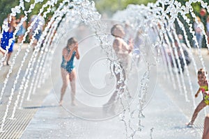 Children play in dry fountain