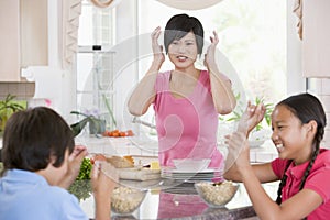 Children Play Fight While Having Breakfast