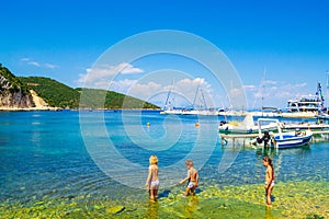 Children play in Frikes beach Ithaca island bay Greece