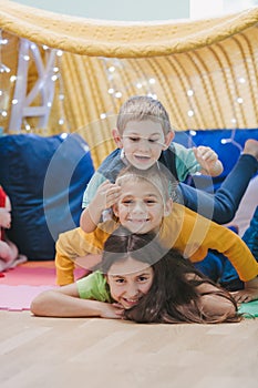 Children play at home with pillows and covered blanket