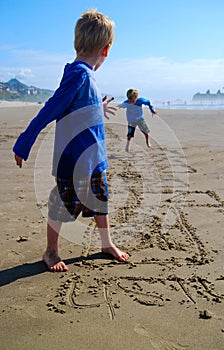 Children Play Hopscotch on Beach