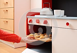 Children play in kitchen. Baking homemade cookies in toy oven