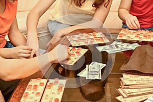 Children play loto and rearrange the chips with their hands photo