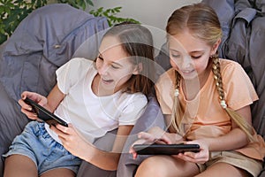 Children play with a mobile phone at home