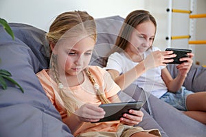 Children play with a mobile phone at home