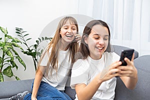 Children play with a mobile phone at home