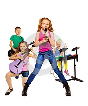 Children play musical instruments as rock group