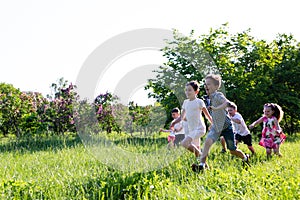 Children play outdoors running and having fun